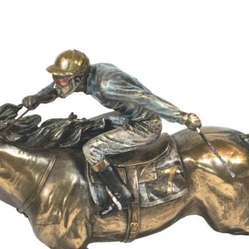 A bronze sculpture of a Jockey racing a horse A bronze sculpture of a Jockey racing a horse